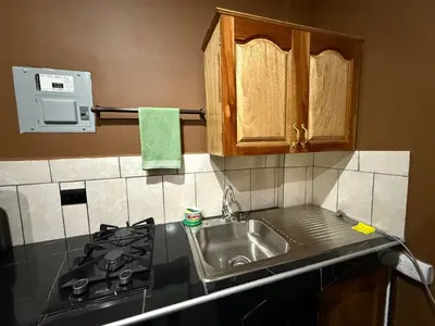 a kitchen with a sink and a stove at El Mangal 2 B&B in Suchitoto