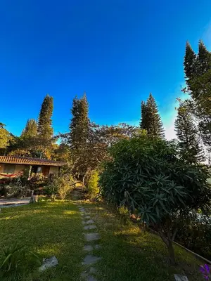 a path in a yard with trees and a house at Finca Santa Lucía - Comasagua - Surf City Highlands in Comasagua