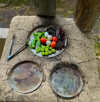 three plates of vegetables on a stone table at Finca Santa Lucía - Comasagua - Surf City Highlands in Comasagua