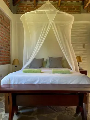 a bed with a canopy in a room at Finca Santa Lucía - Comasagua - Surf City Highlands in Comasagua
