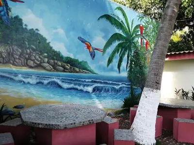 a painting of a beach with a bird flying over it at Rincon del mar in La Libertad