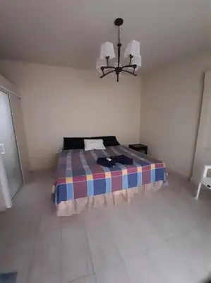 a bedroom with a bed in a white room at Rincon del atardecer in La Libertad