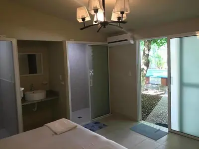 a bedroom with a bed and a bathroom with a sink at Rincon del atardecer in La Libertad