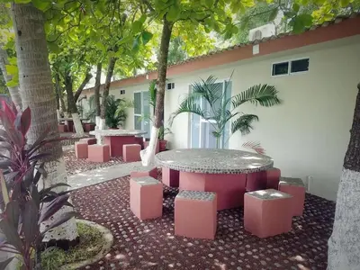 a group of tables and stools in a courtyard at Rincon del atardecer in La Libertad