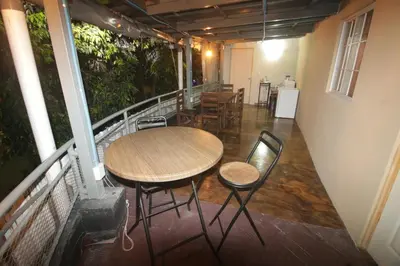 a table and chairs sitting on a balcony at Suite panorámica con terraza in San Salvador