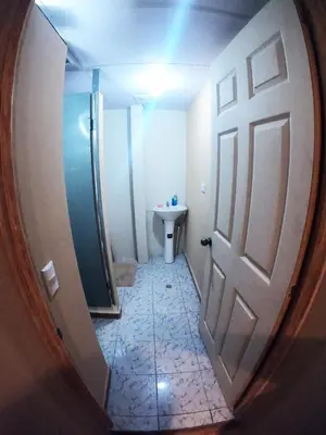 a small bathroom with a door and a toilet at Suite panorámica con terraza in San Salvador