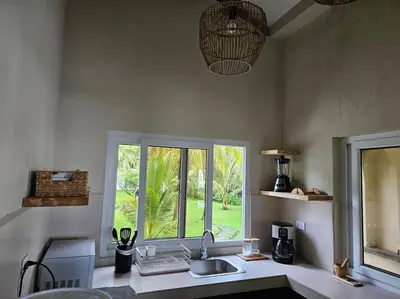a kitchen with a sink and a window at Villa San Juan, playa Costa Azul in Acajutla