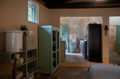a kitchen with green cabinets and a refrigerator at Finca Life - Surf City Highlands - Comasagua in Los Amates