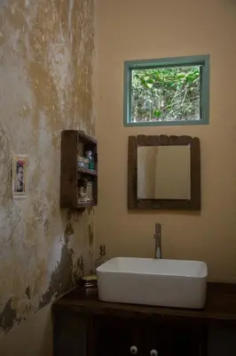 a bathroom with a sink and a mirror at Finca Life - Surf City Highlands - Comasagua in Los Amates