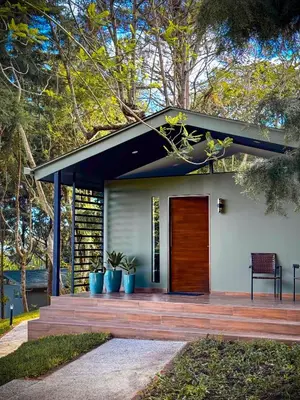 a house with a wooden door on a deck at Cajamarca Villas by Collection in Las Delicias