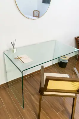 a glass table with a chair and a mirror at Cajamarca Villas by Collection in Las Delicias