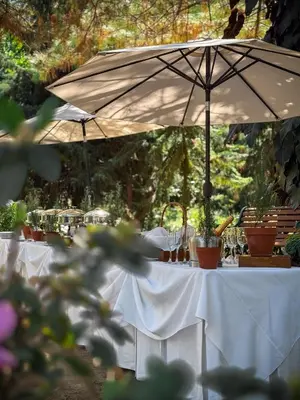 a table with a white table cloth and an umbrella at Cajamarca Villas by Collection in Las Delicias