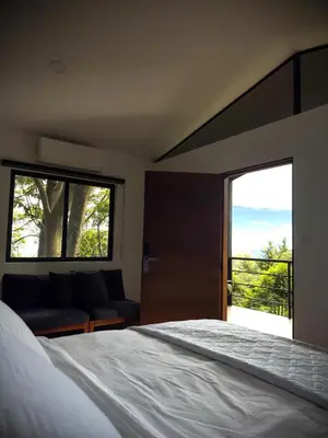 a bedroom with a bed and a couch and a window at Cajamarca Villas by Collection in Las Delicias