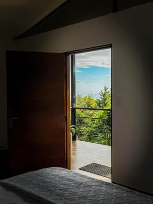 a bedroom with a door open to a balcony at Cajamarca Villas by Collection in Las Delicias