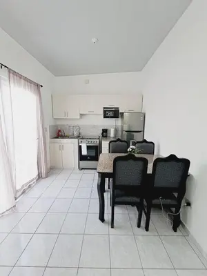 a kitchen with a table and chairs in a room at Casa tonykey in San Miguel