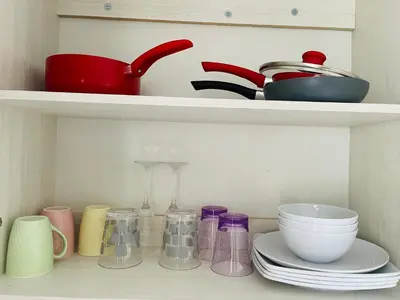a shelf filled with dishes and bowls and utensils at Casa tonykey in San Miguel