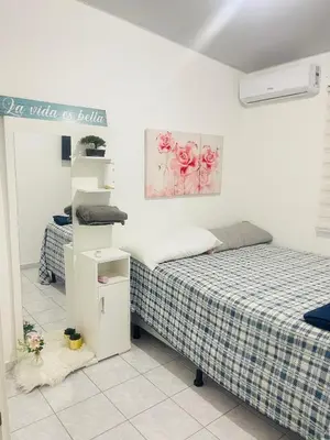 a bedroom with two beds and a sign on the wall at Casa tonykey in San Miguel