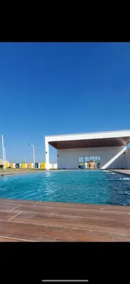 a building with a pool of water in front of it at Casa tonykey in San Miguel