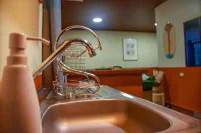 a kitchen sink with a faucet on top of it at Coral Beach in Tamanique