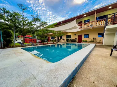a swimming pool in front of a building at Coral Beach in Tamanique