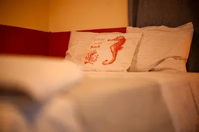 a bed with a pillow with a snake on it at Coral Beach in Tamanique