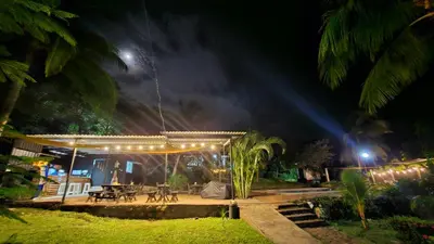 a pavilion with a table and lights at night at Jaco Mizata Beach and River in Las Piedras