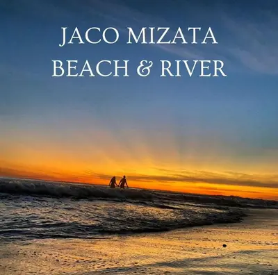 a group of people walking on the beach at sunset at Jaco Mizata Beach and River in Las Piedras