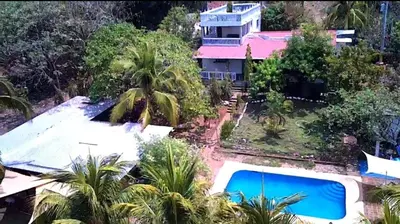 an aerial view of a house with a swimming pool at Jaco Mizata Beach and River in Las Piedras