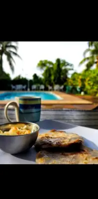 a table with a bowl of food and a plate of food at Jaco Mizata Beach and River in Las Piedras
