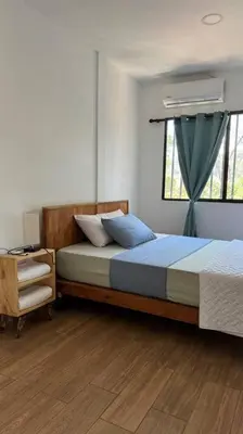 a bedroom with a large bed and a window at Apartment Casa Melodia in Chirilagua