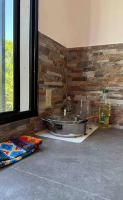 a bathroom with a sink and a brick wall at Apartment Casa Melodia in Chirilagua