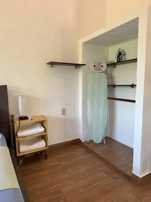 a room with a room with a bed and shelves at Apartment Casa Melodia in Chirilagua