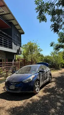 a blue car parked in front of a house at Apartment Casa Melodia in Chirilagua