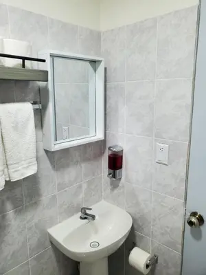 a bathroom with a white sink and a mirror at Casita Jardin in San Salvador