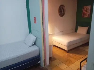 a room with two beds in a room at Hostal Brunette Santein in Santa Ana