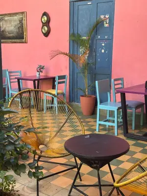 a patio with tables and chairs and a table at Hostal Brunette Santein in Santa Ana