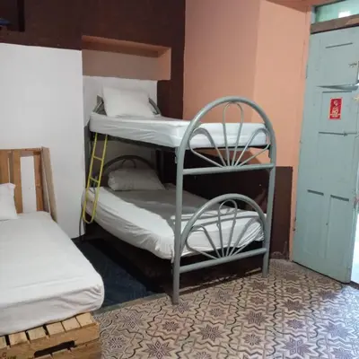 a room with two bunk beds in a room at Hostal Brunette Santein in Santa Ana