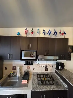 a kitchen with a sink and a counter top at La Casita del Viajero in Santa Ana