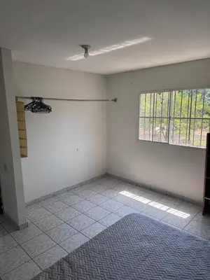 an empty room with a window and a tiled floor at Nawa Kalli Surf House in El Sunzal