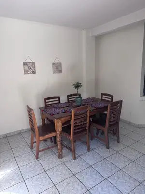 a dining room table with chairs and a potted plant on it at Nawa Kalli Surf House in El Sunzal