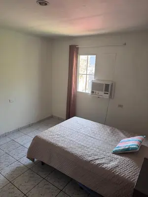a bedroom with a bed and a window at Nawa Kalli Surf House in El Sunzal