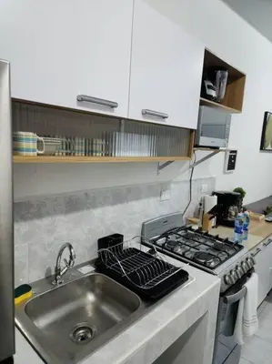 a kitchen with a sink and a stove at Casa Villa El Escape en Residencial Villa Panamericana in San Miguel