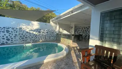 a swimming pool in the backyard of a house at El Rinconcito in La Libertad