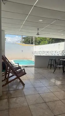 a patio with a table and chairs and a swimming pool at El Rinconcito in La Libertad