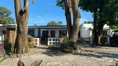 a house with trees in front of it at El Rinconcito in La Libertad