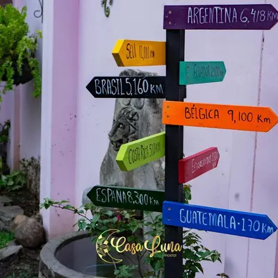 a pole with street signs in front of a building at Hostal Casa Luna in Santa Ana