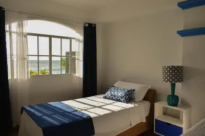 a small bedroom with a bed and a window at Casa Coral in Los Cóbanos