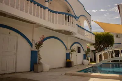a villa with a swimming pool and a building at Casa Coral in Los Cóbanos