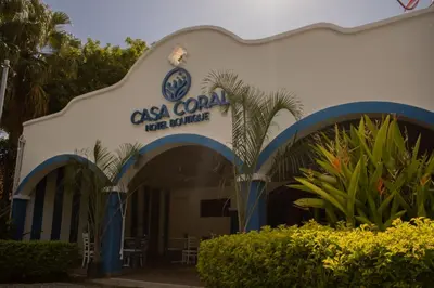 a building with a sign for a restaurant at Casa Coral in Los Cóbanos