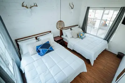 a room with two beds and a couch and a window at Cabo in Las Hojas
